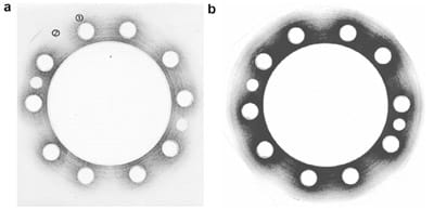 Fig. 3. High (a) and medium (b) pressure sensitive paper after pressure application at 300 N m bolt torque.