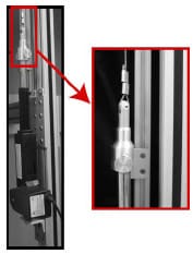 Figure B-1: LEFT - A brush-drive DC motor was rigidly mounted to the rig frame. RIGHT - A custom designed coupler interfaced the linear actuator and 5/64” diameter stainless steel wire rope. A tracking device constructed from 80/20-10 series (80/20 Inc.; Columbia City, IN) prevented rotation of linear shaft during translation.