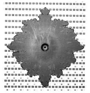 Fig. 11. Flow of highly filled EMC over an assembled ceramic panel, injected with a pin gate.